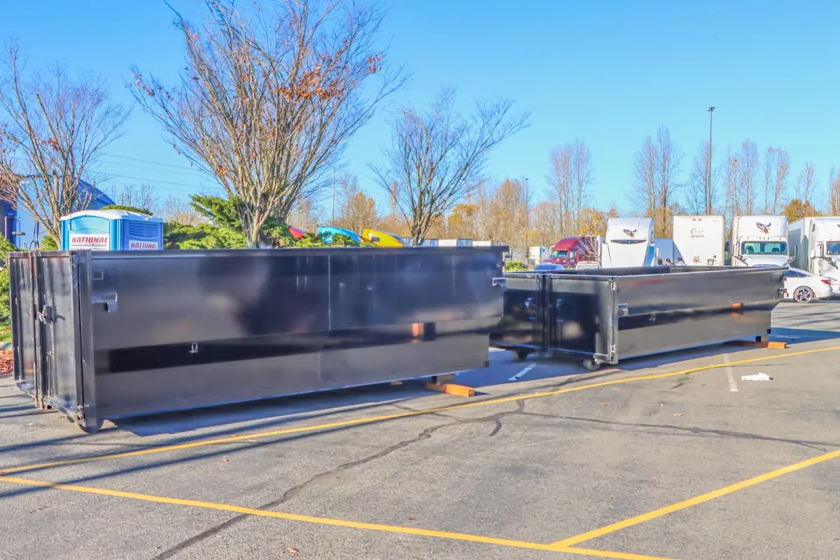 Professional dumpster rental service with roll-off container on residential driveway in Redwood City